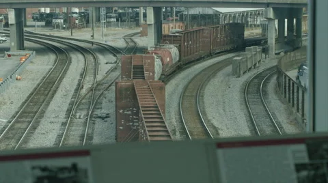 Cargo train moving under a vehicle bridge 스톡 동영상 67553766