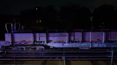 Cargo Train Passing on Elevated Track at Night Stock Footage 339221501