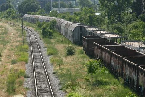 Cargo train platform railway tracks in a rural scene, empty railway container Stock Photos