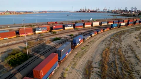 Cargo train at a the port of Long Beach | Aerial Descending Flight Stock Footage 160313292