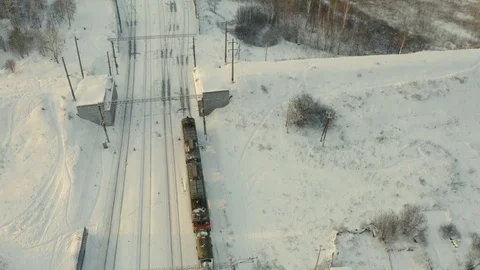 Cargo train pulls up to the station , winter landscape, forest, many railway Stock Footage 126359580