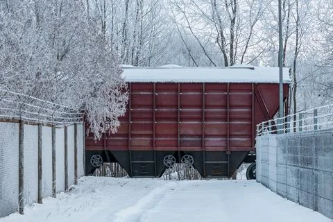 Cargo train rides through a snow covered railway line Stock Photos