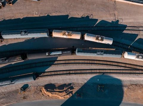 Cargo train waiting to be filled in an oil refineries. Stock Photos
