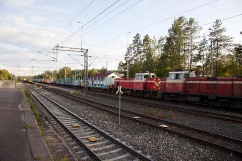 Cargo train waiting at switch track at railroad station, Finland Stock Photos