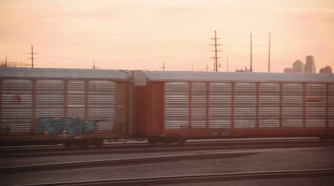 Cargo trains pass by with sunset 스톡 동영상 66748756