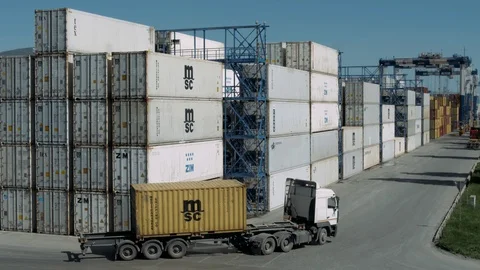 Cargo truck with container moves between rows with cargo containers in the port Stock Footage 89366427
