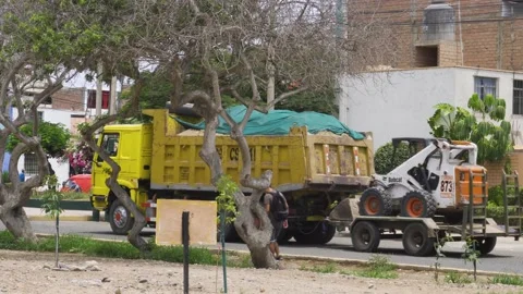 A cargo truck pulling a small tractor on top of a cart 動画素材 149905464