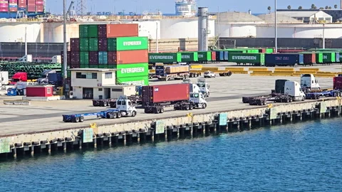 Cargo trucks transporting shipping containers at various stages of transit in Видео 331154349