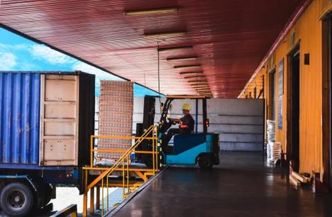 Cargo unloading from container activities at distribution warehouse. Stock Photos