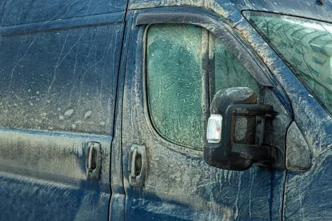 A cargo van covered in a layer of dirt. Stock Photos