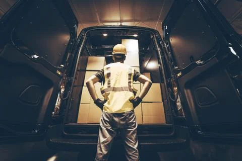 Cargo van delivery. rear cargo doors reloading. construction guy talking care Photos