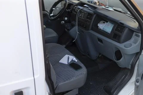 Cargo van interior with cluttered passenger area and documents Foto stock