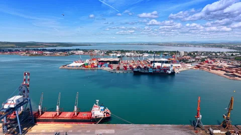 Cargo Vessel Berthed At Container Terminal With Cranes Vídeos de archivo 334933786