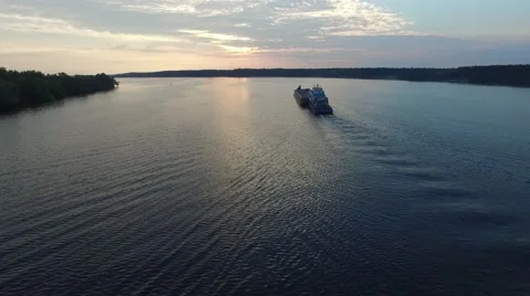 Cargo vessel floating in the river at dawn. Aerial view. Stock Footage 64802489