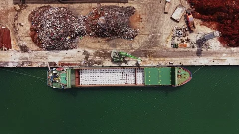 Cargo vessel loading goods at the port near industrial area 動画素材 338325072
