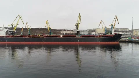 Cargo vessel with Murmansk city on background. Preparation for loading of Stock Footage 203920083