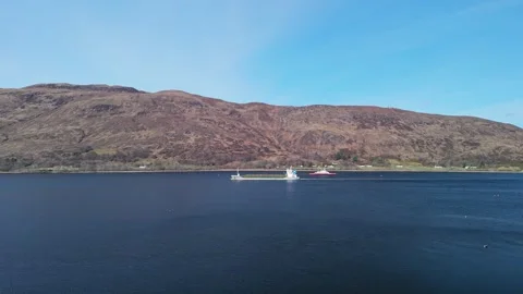 Cargo vessel sailing down Loch Linnhe with Highland mountains behind, Fort Stock Footage 341315750