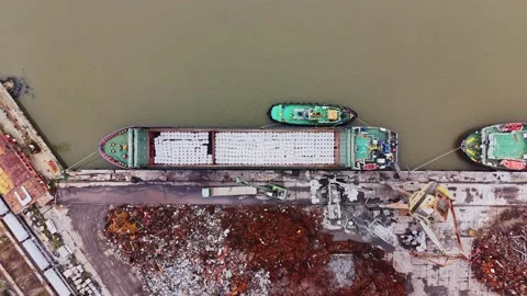 Cargo vessel at a shipyard loading goods near waterway Stock Footage 337940944