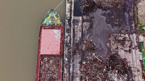 Cargo vessel at shipyard loading materials by the riverbank 動画素材 337941042