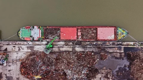 Cargo vessel is at the shipyard for unloading waste material at river dock Stock Footage 337942056