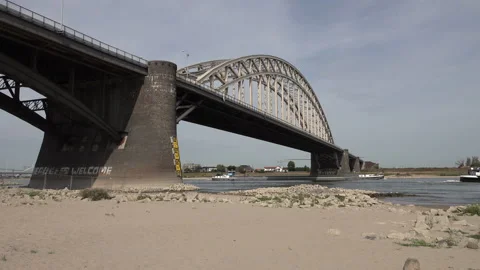 Cargo vessel under bridge, low water levels in dry Summer Europe Stock Footage 220786538