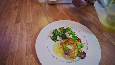 Caribbean chef adding cream to pan seared cod Stock Footage 267007951