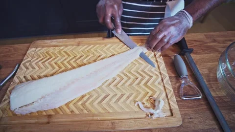 Caribbean chef preparing cod fish on a chopping board Stock Footage 267007720