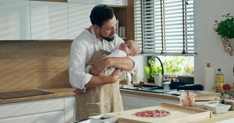 Caring bearded man father taking care of newborn baby holding in hands carefully Stock Footage 218641679