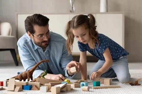 Caring dad have fun playing with daughter Stock Photos