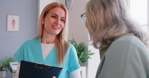 Caring doctor, nurse explaining, geriatric kind medicine in clinic, nurse Stock Footage 313251795