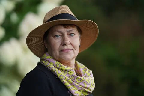 Caring for the elderly, caring for old parents, the happy old lady in the hat Stock Photos