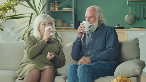 A Caring Elderly Husband Brings Tea To His Beloved Wife, Shows Care, Warms Stock Footage 163750099