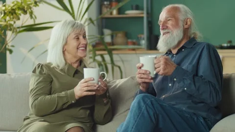 A Caring Elderly Husband Brings Tea To His Beloved Wife, Shows Care, Warms Stock Footage 163750198