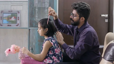 Caring father combing his daughter's hair at home - Modern Indian Lifestyle Video stock 153259080