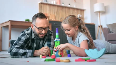 Caring father playing with daughter constructing fairytale castle cubes spending 動画素材 165295260