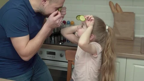 Caring father spending time with his daughter playing with food in the kitchen Stock Footage 301443051