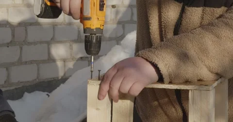 A caring father teaches his son woodworking skills. They build a wooden bird Video stock 328028276