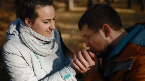 Caring guy warming the hands of his girlfriend Stock Footage 65468381