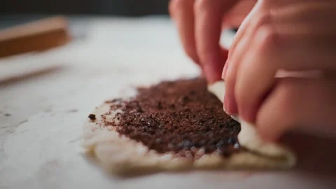 Caring hands craft a pastry with rich filling 库存影片 336050933