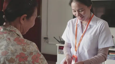 Caring Interaction Between Nurse and Patient Stock Footage 314003695