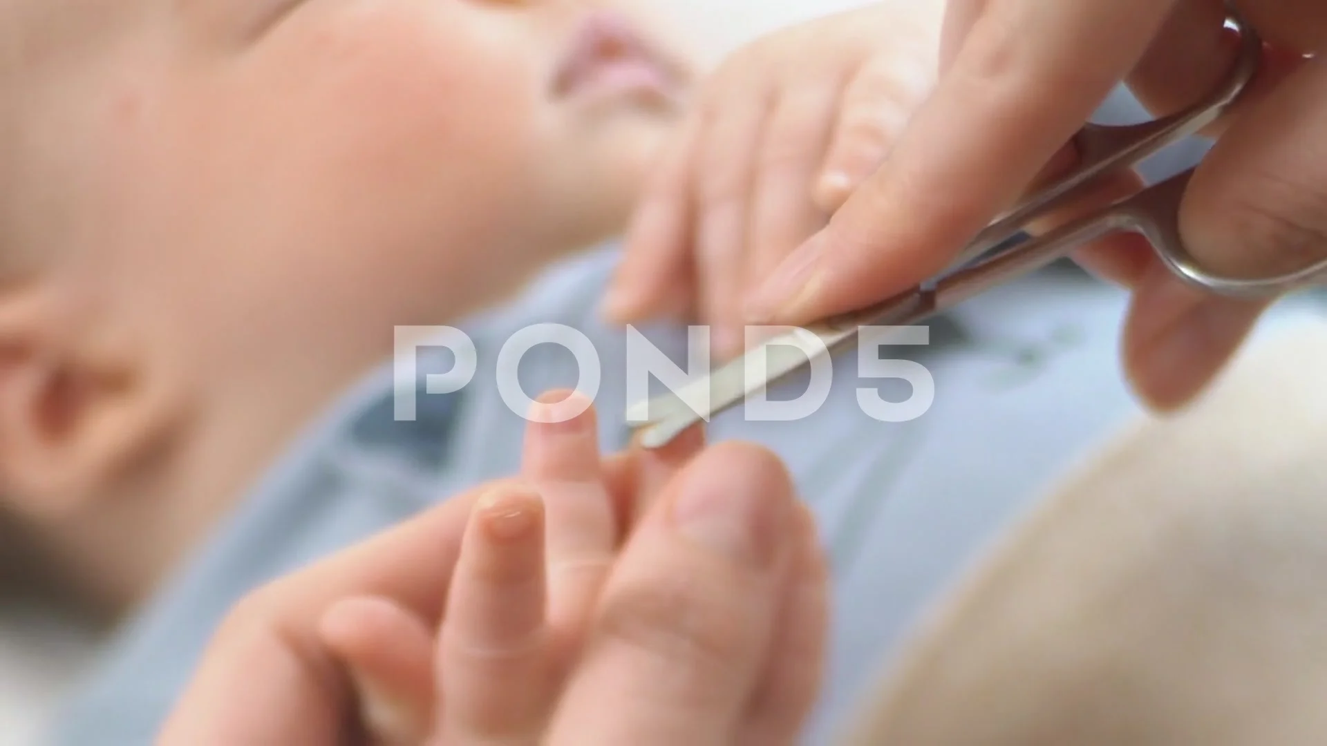 Premium Photo | Mom cuts toenails of a newborn baby with metal scissors.  selective focus