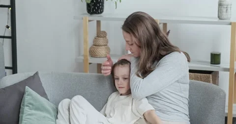 Caring mother calm down and hugging little adorable son sitting together on Stock Footage 163979926