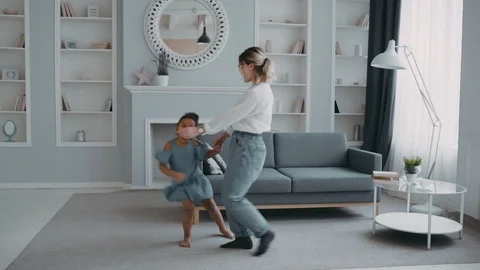 Caring mother having fun and cool time dressed in white shirt dress concept Stock Footage 126965370