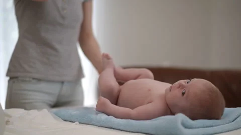 Caring mother lovingly playing with her newborn baby Видео 338369241