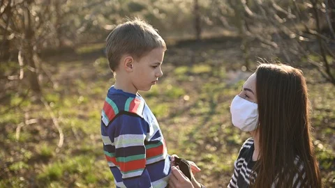 Caring mother puts her son on a mask to protect against viruses Stock Footage 126695607