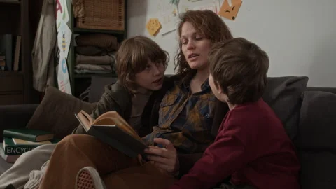 Caring Mother Reading Book for her Children on Couch Stock-Footage 333761517