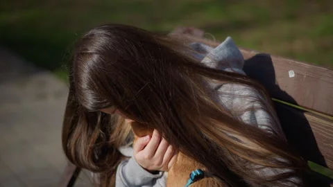Caring woman embraces tiny pet, gentle girl holds small dog lovingly, intimate Stock Footage 323220771