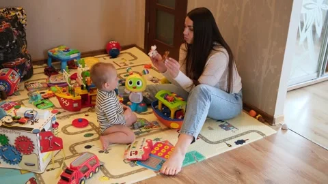 Caring young mother and her adorable baby boy spending quality time together Video stock 342951429