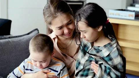Caring young mother, talking to children, comforting sad children, help solve Stock Footage 220070182