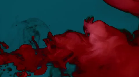 Carmine red smoke on a plain dark blue background, creating volutes and swirls Stock Footage 65330455